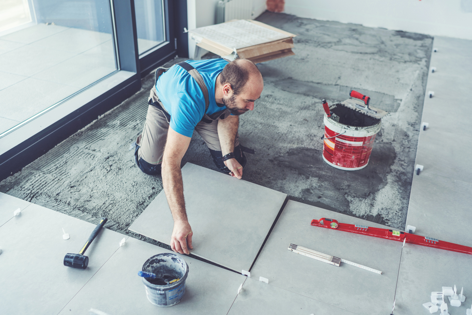 Tiler laying tiles on the floor